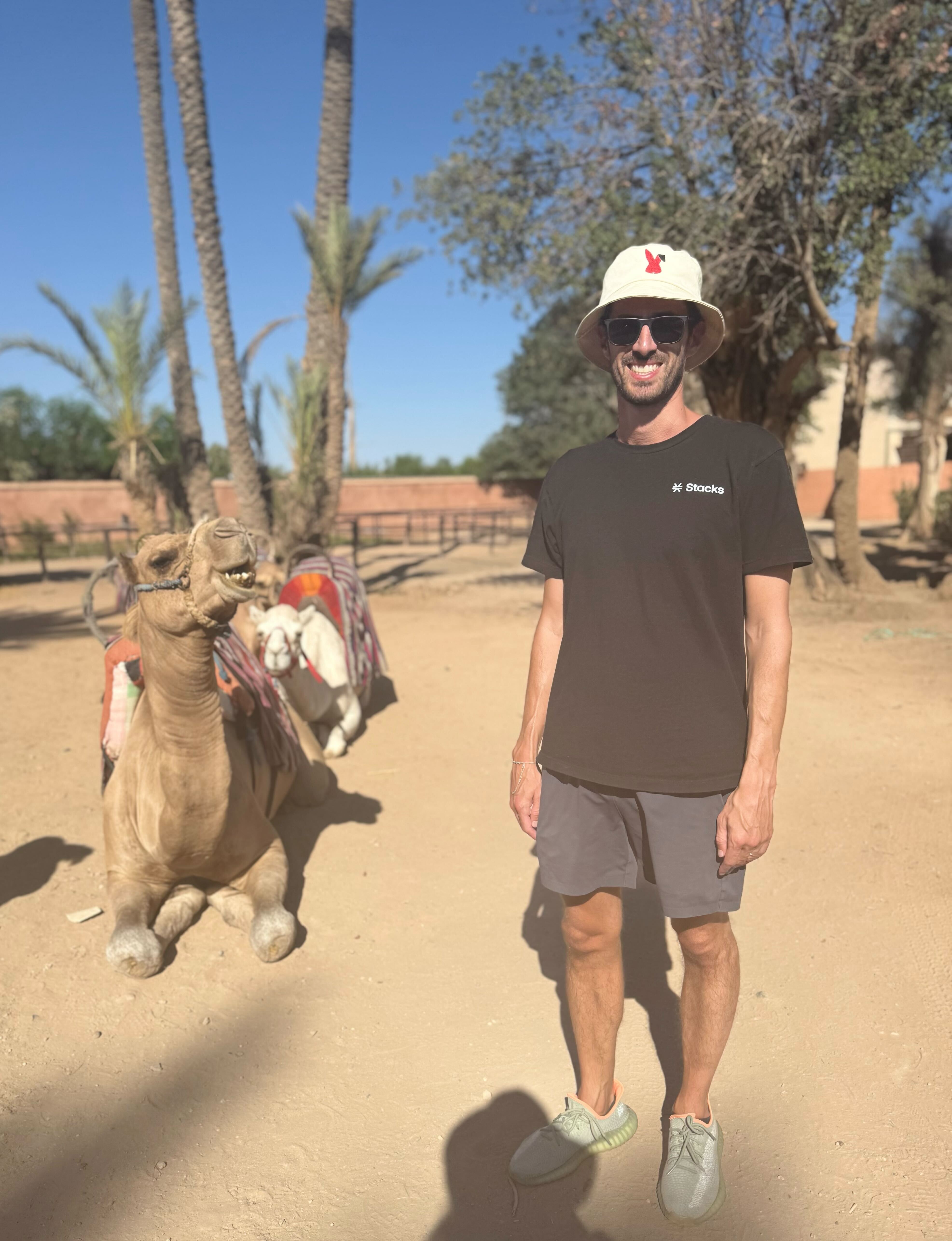 Kyle Libra in Morocco standing next to a camel